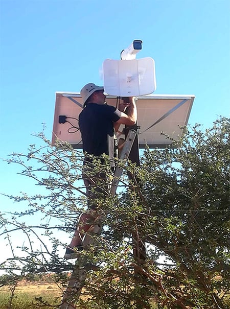 Mann installiert Wifi im Baum, Namibia