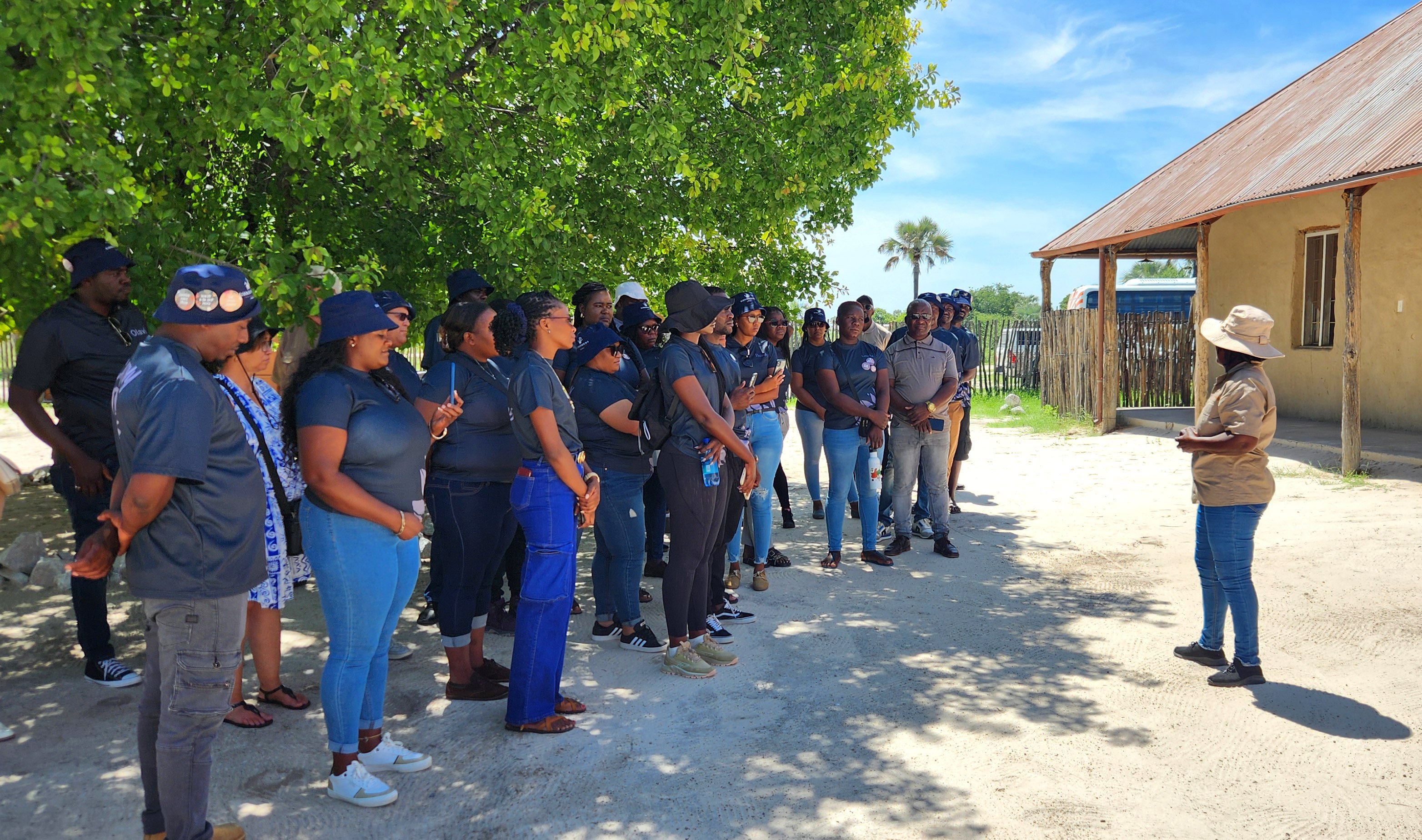 Group of Namibians under tree listening