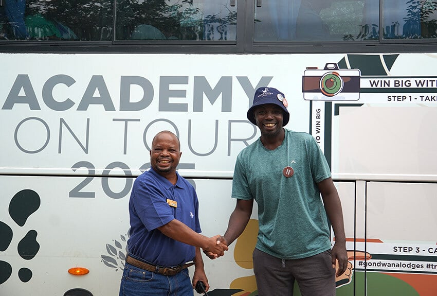 Namibian men in fornt of Gondwana Academy bus, Namibia