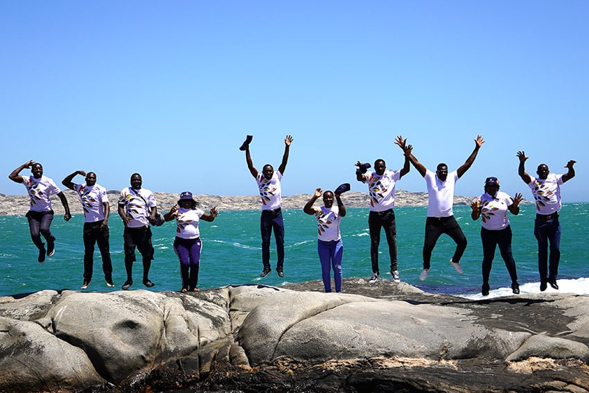 Namibians jumping for joy, ocean, Namibia