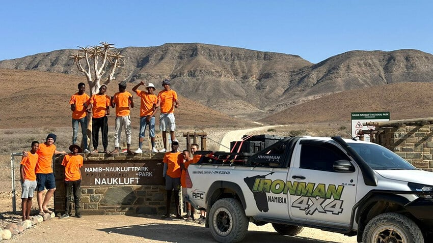 Namibians and car at Namib-Naukluft entrance gate, Namibia web