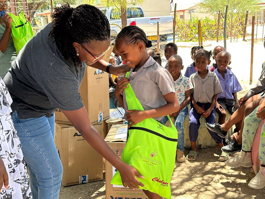 Namibian women handing over a gift to a child