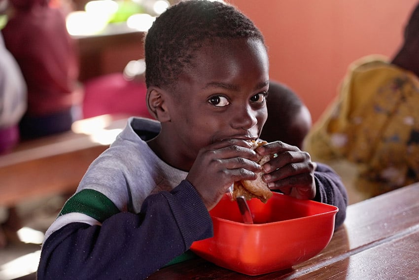 Namibian child eating, Promiseland project, Namibia