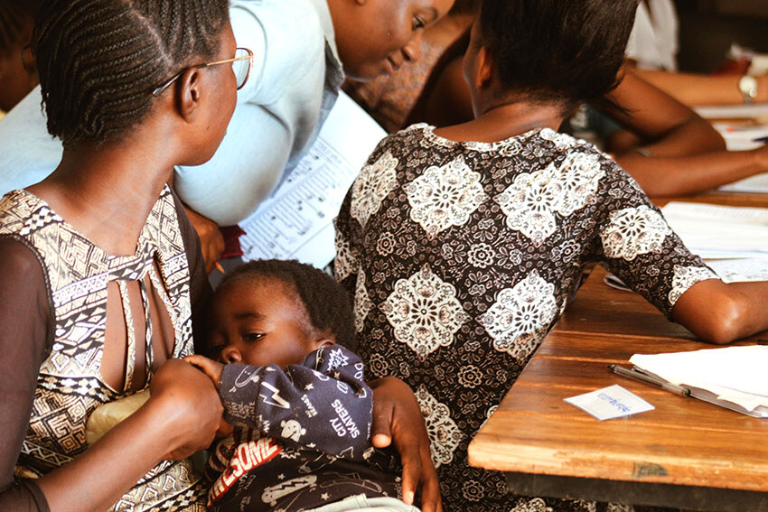 Mother bottle-feeding baby, Namibia