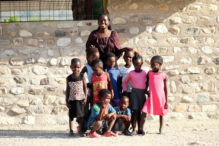 Namibian teacher lining up with some children