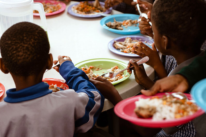 Namibian children eating from colourful plates