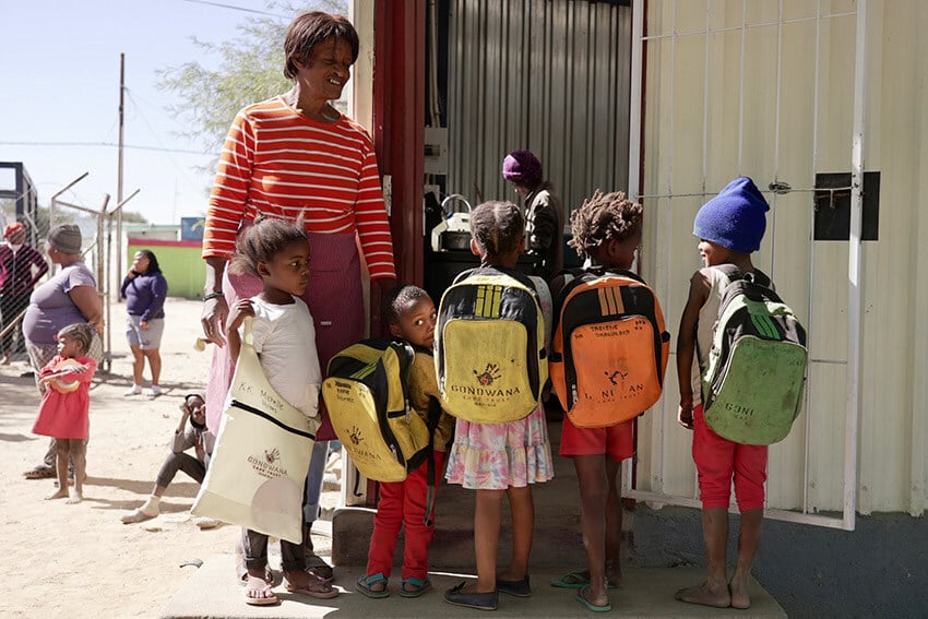 Children with Gondwana christmas bags and a teacher at Khaibasen Community Centre, Namibia