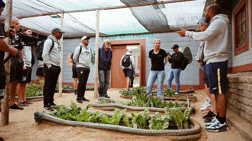 Visitors lokking at a vegetable garden, Namibia