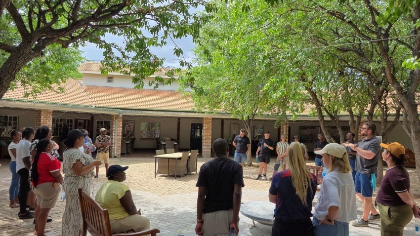 Employees of Gondwana Collection Namibia standing together and learning system training