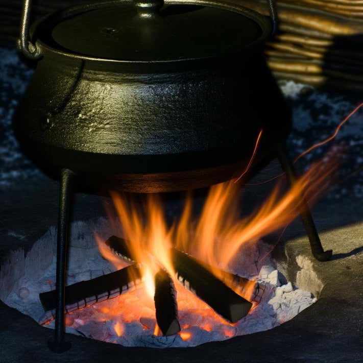 3 legged black pot on fire
