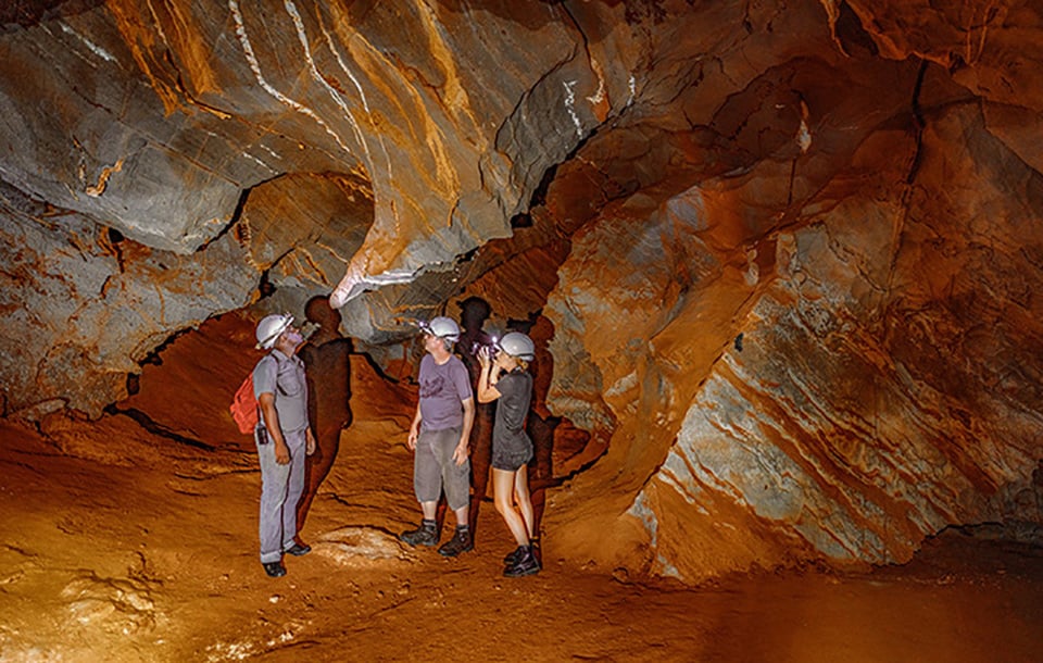 3 people in Ghaub Cave, Namibia