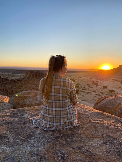 Woman watching sunset, southern Namibia