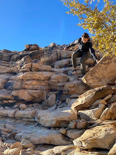 Women climbing rocks, Namibia