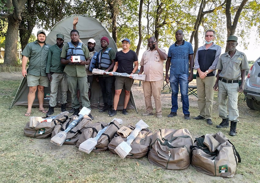 Sikunga fish guards and other people in front of tent reveiving donation, Namibia 