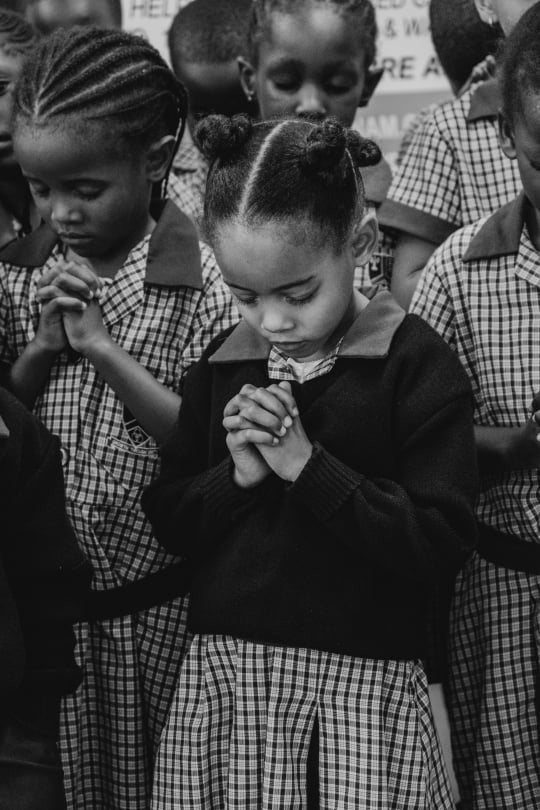 Focus on little girl praying. Okahandja, Namibia