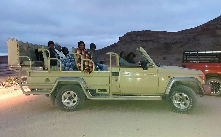 Safari vehicle departing in the early morning, Namibia