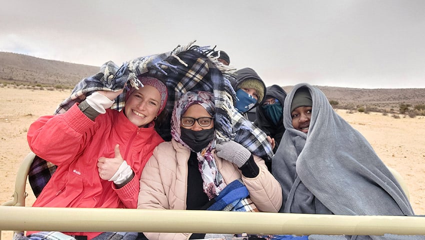 People at a game drive in Namibia in freezing cold