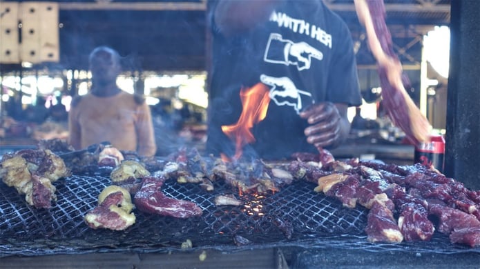 Kapana Master with meat on grill at Single Quarters, Windhoek