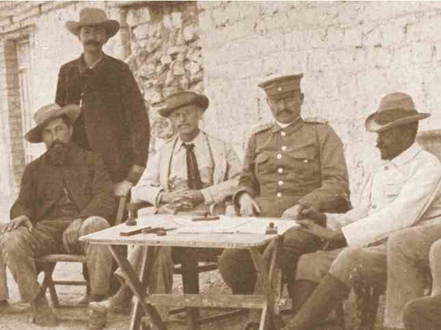 Signing of agreement between governor Leutwein, commandant Lombard (left), Dr Hartmann (2nd f.l.) and Samuel Maharero (right); standing translator Kleinschmidt; Grootfontein, 1895. Photo Collection: National Archives of Namibia