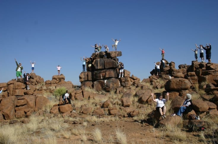 Group of people climbing rocks in Namibia