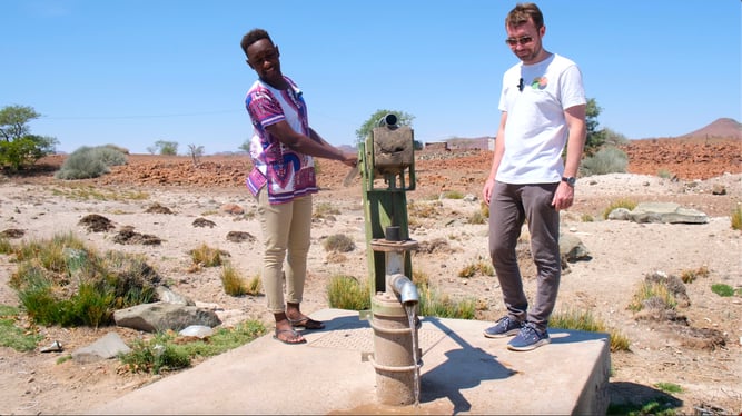 Bentjie Tourob (Palmwag Assistant Lodge Manager) and Nick Murphy (Our Sustainable World) at a water pump in Palmwag, Namibia