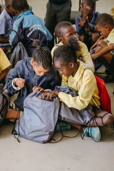 School kids looking at schoolbags and staitionery in the Kunene Region Schools after recieving donations through Gondwana Care Trust Namibia and Help4Nam