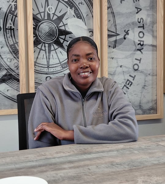 Woman sitting in a boardroom, Viktoria Namene Chef Apprentice at Gondwana Collection Namibia