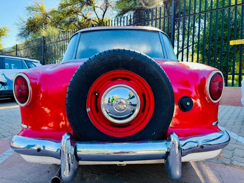 Rear view of the 1957 Nash Metropolitan Series III Hardtop, soon to become part of Gondwana Collection Namibia’s Canyon Roadhouse, showing its curved trunk, chrome bumper, small round tail lights, and charming retro proportions.