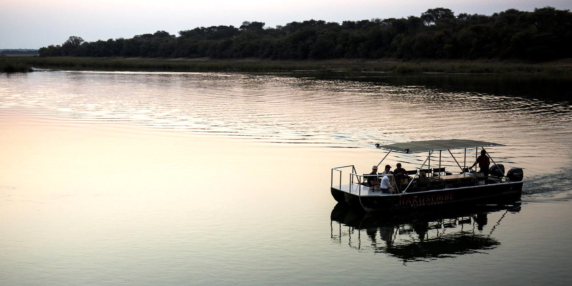 Boat cruise on Okavango River at sunset, Namibia