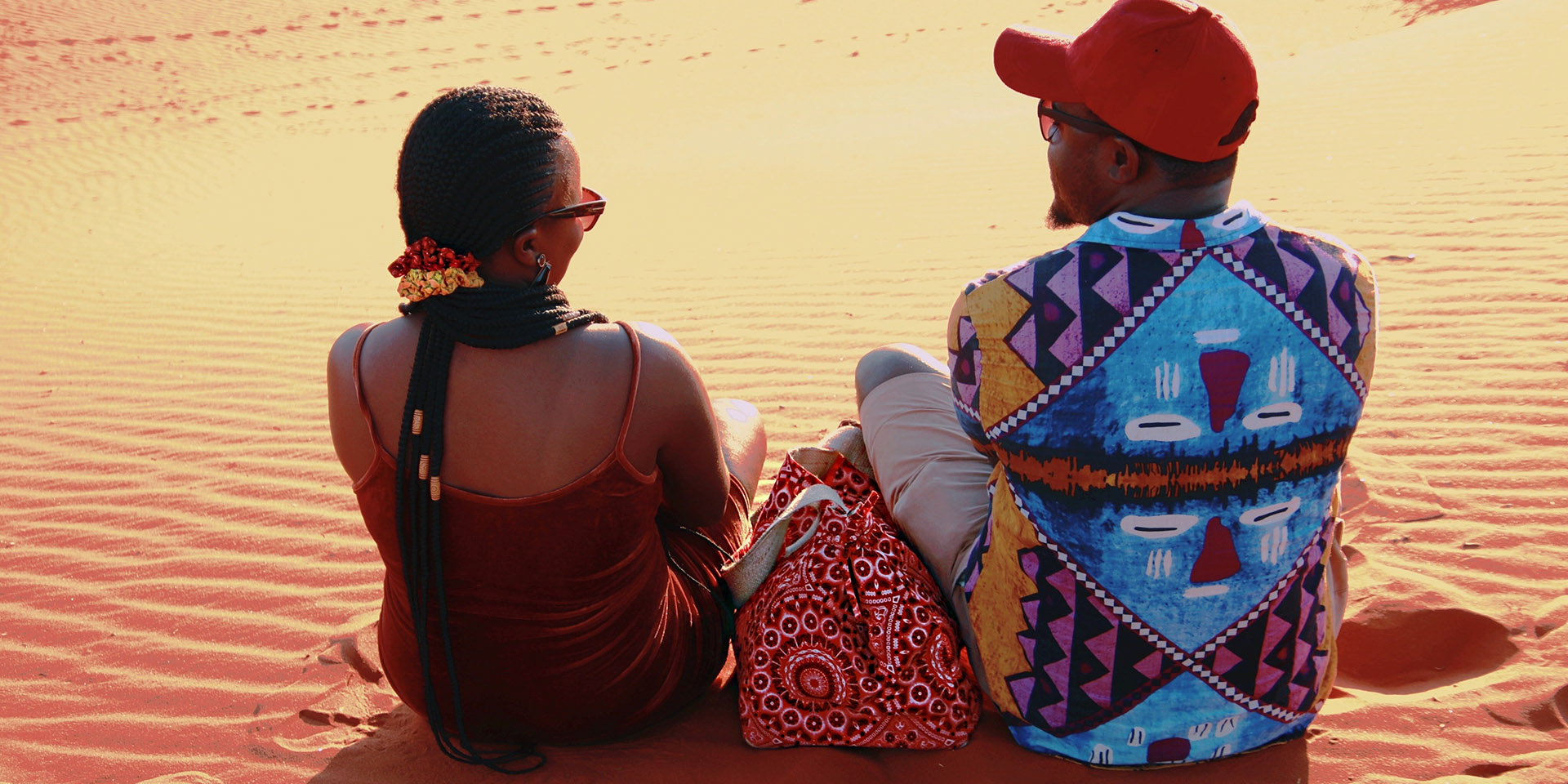 Couple on a dune in the desert, Namibia