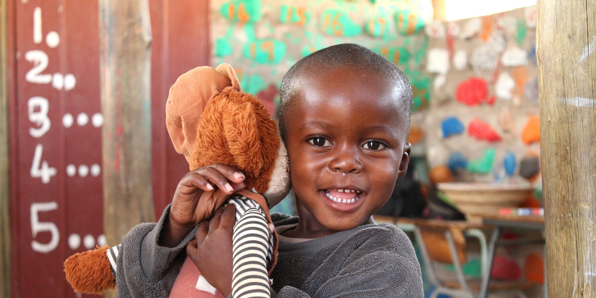 Happy Namibian child with a plush toy