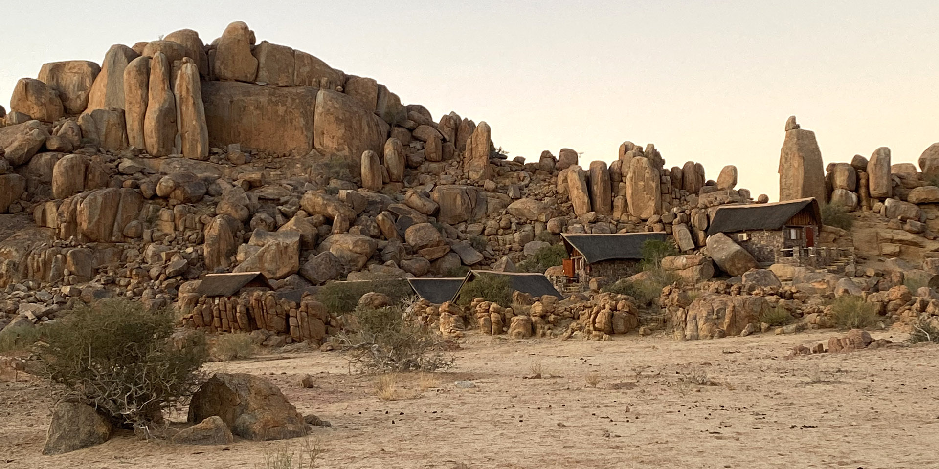 Chalets against rock cliff, Canyon Lodge, Namibia