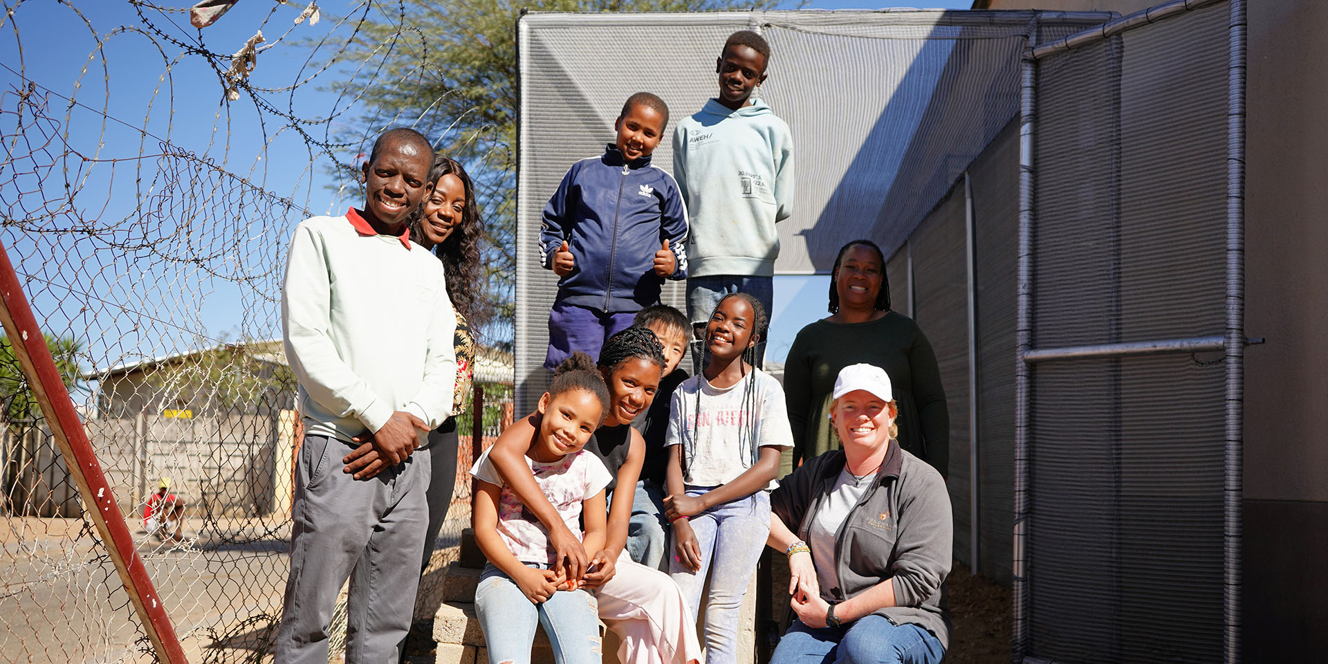 Smiling adults and children, The Lighthouse Community Hope, Namibia