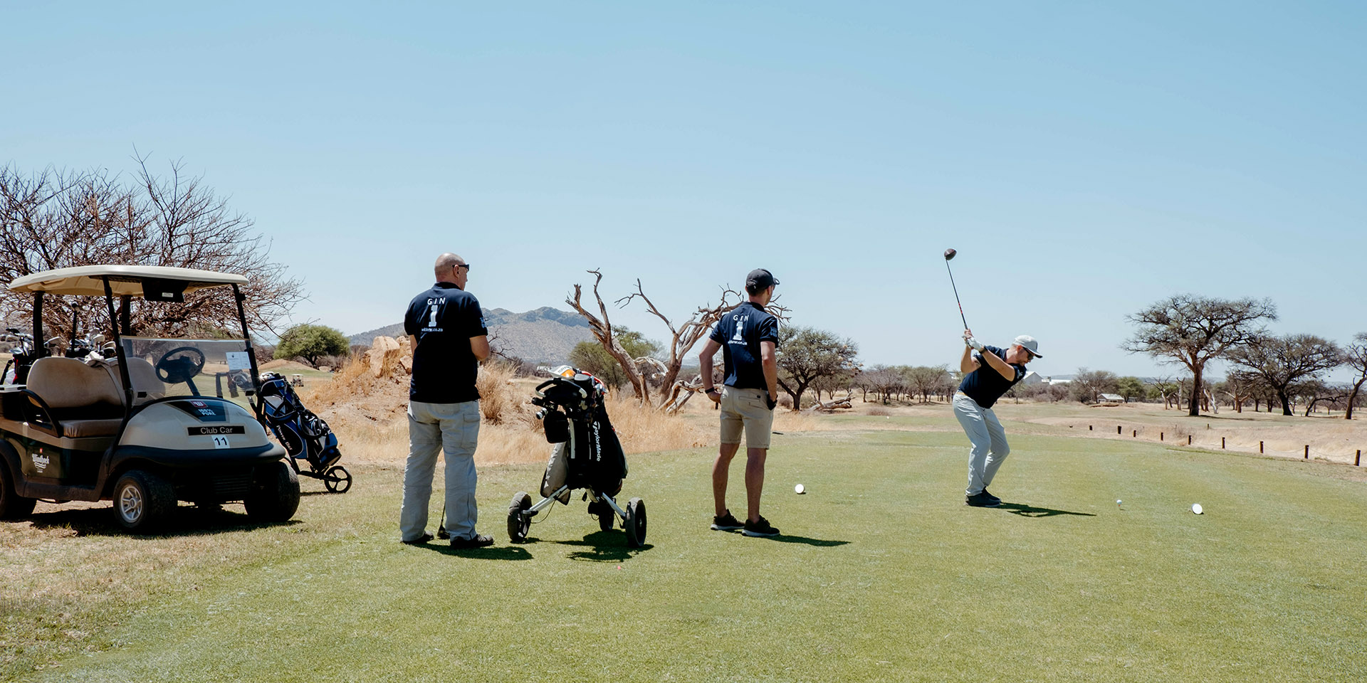 Golf players on green, Namibia