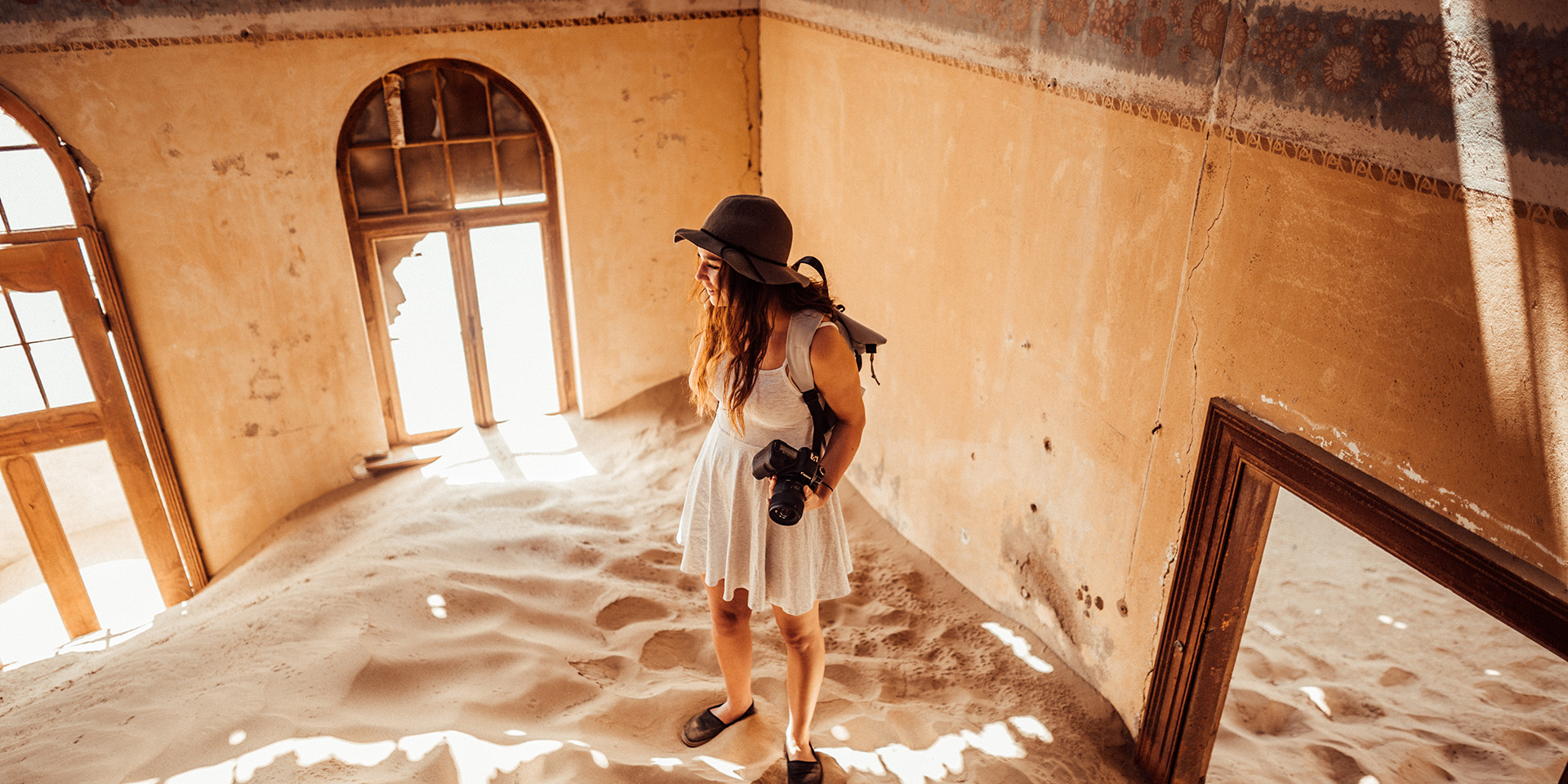 Woman in sandy room, Kolmanskop