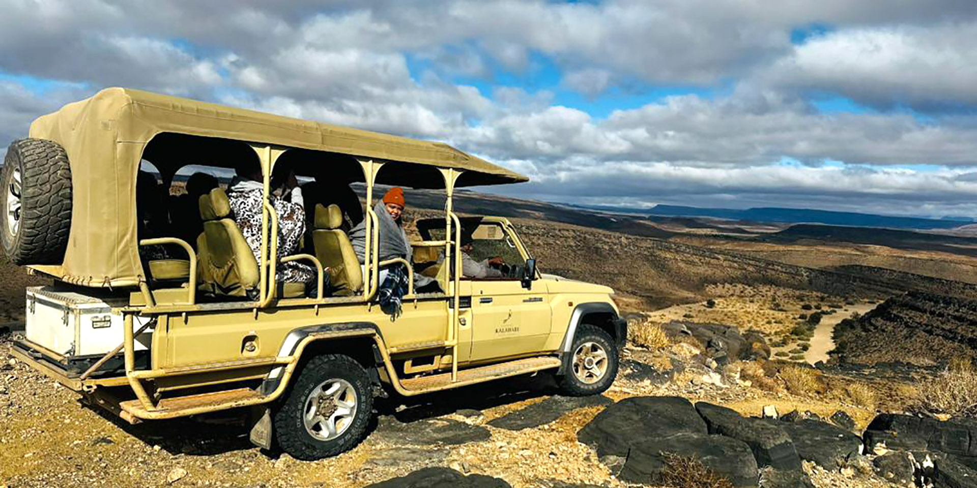 Safari vehicle at canyon rim, Namibia