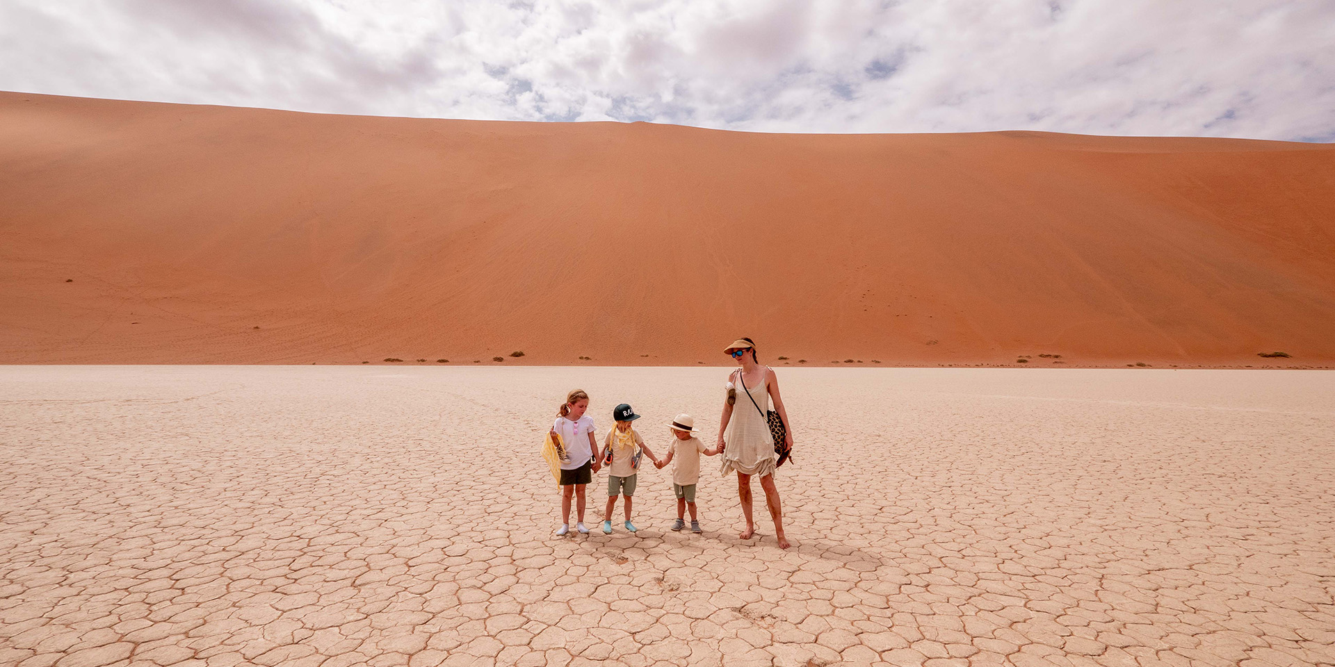 Mother and children in Namibia's dunes