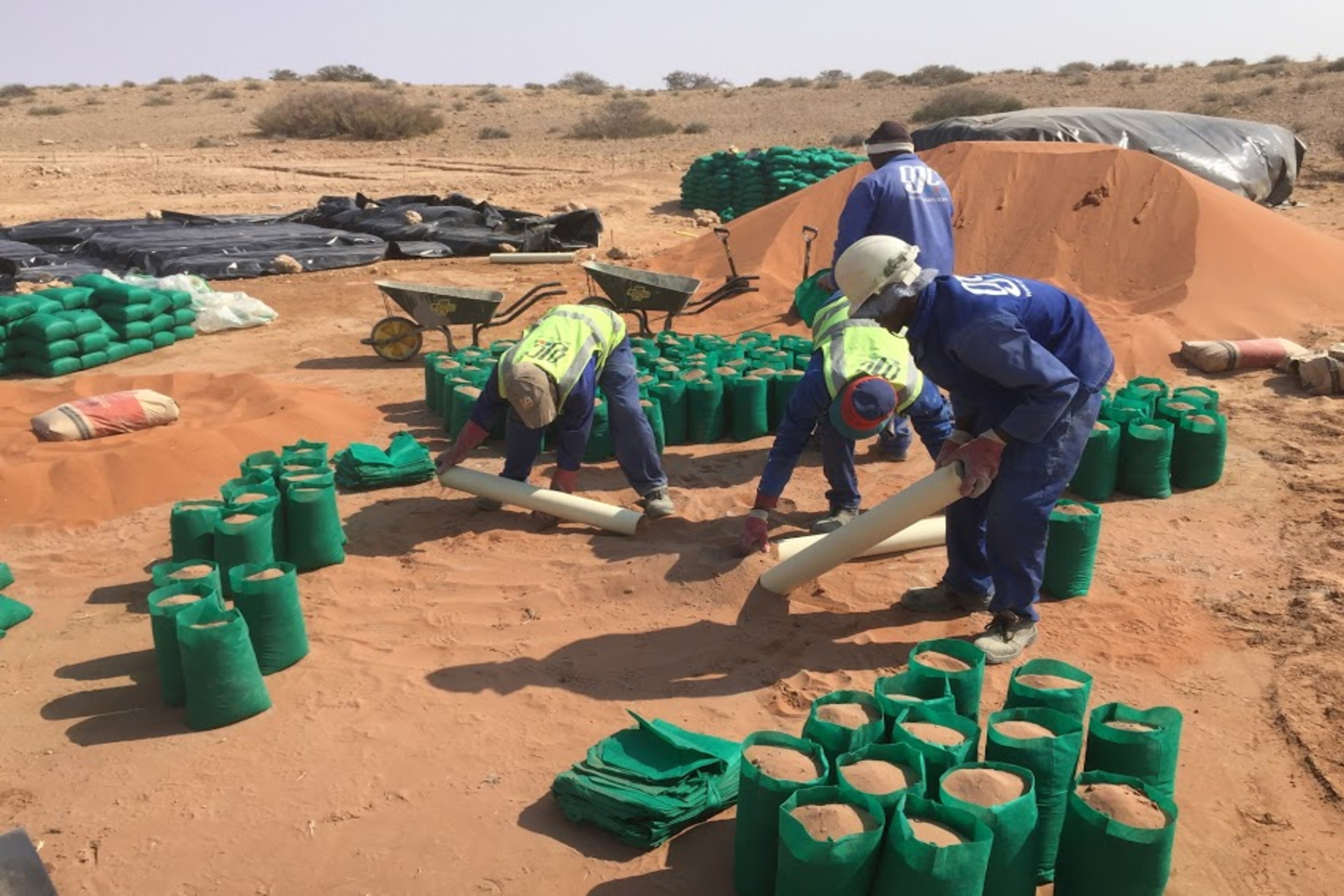 Filling sand bags for sustainable construction, The Desert Grace lodge, Namibia