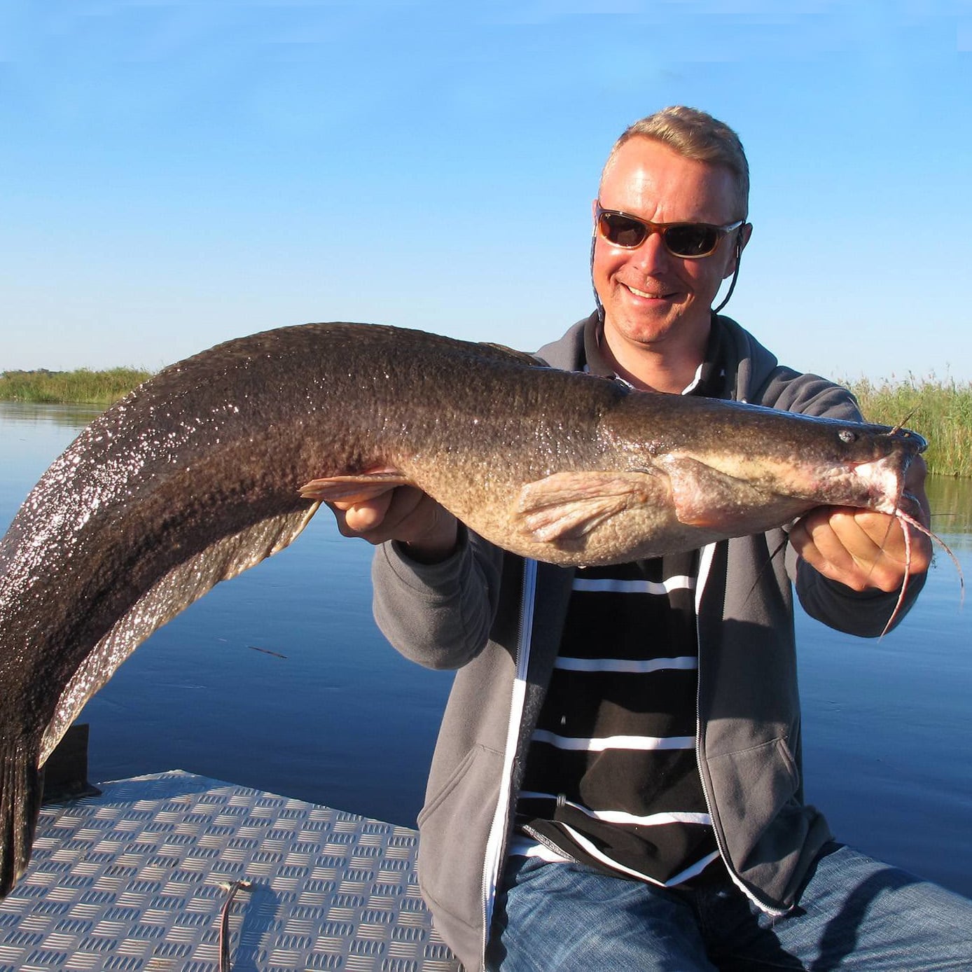Fisherman with a huge catfish, Zambezi, Namibia