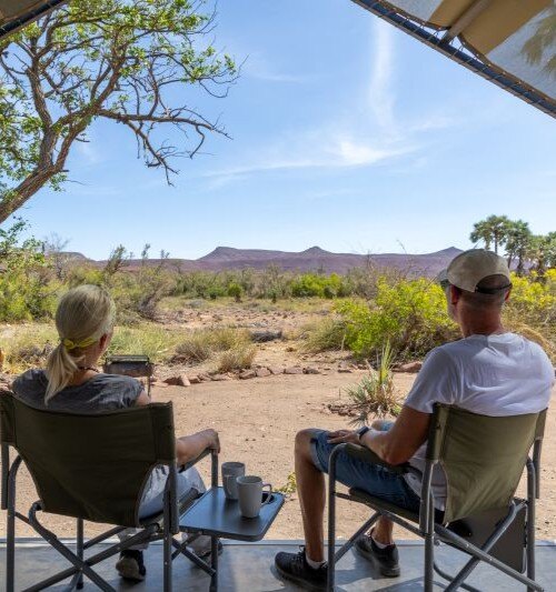 couple facing Etendeka mountains, Namibia