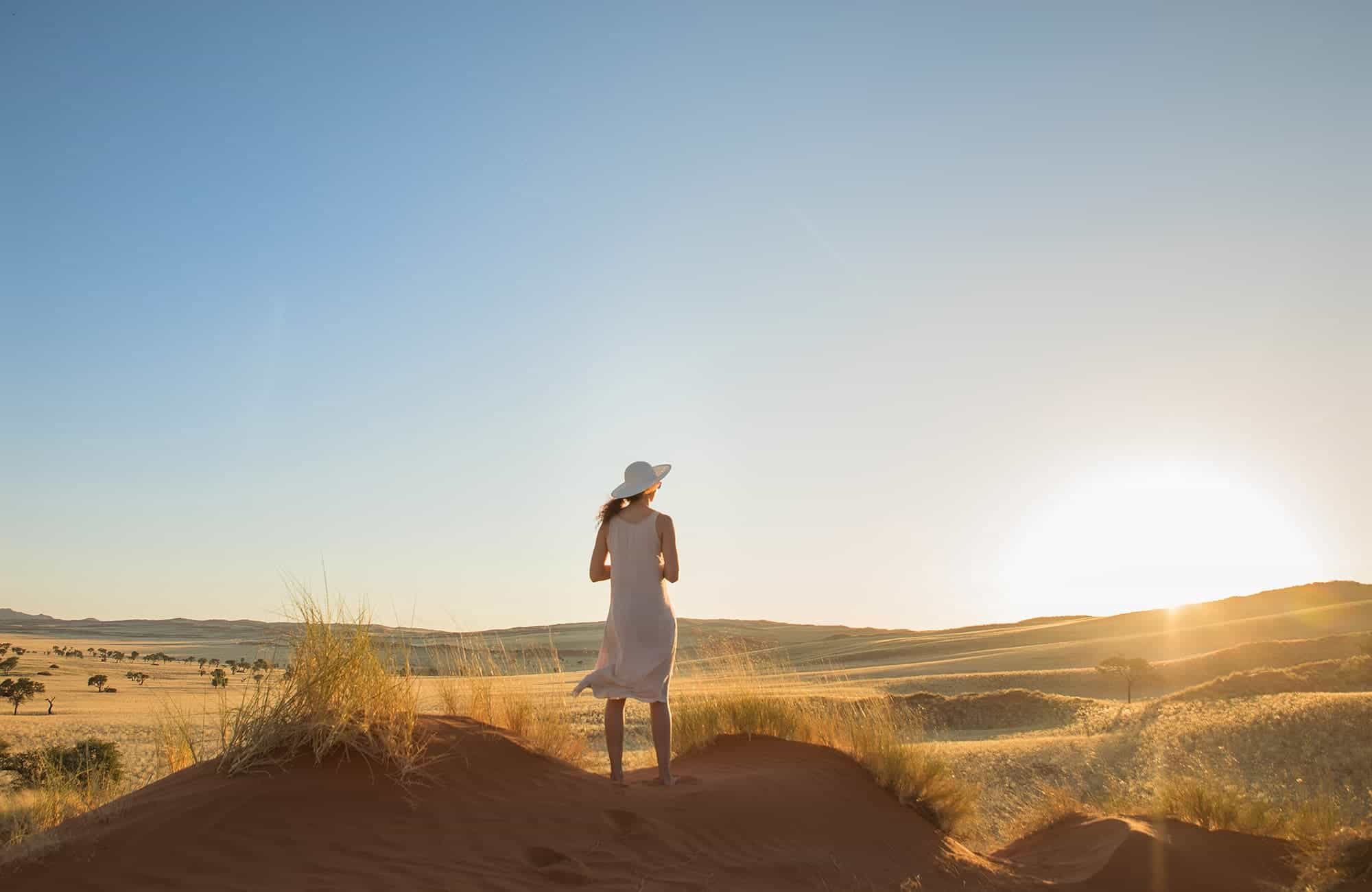 Woman on Dune overlooking veld