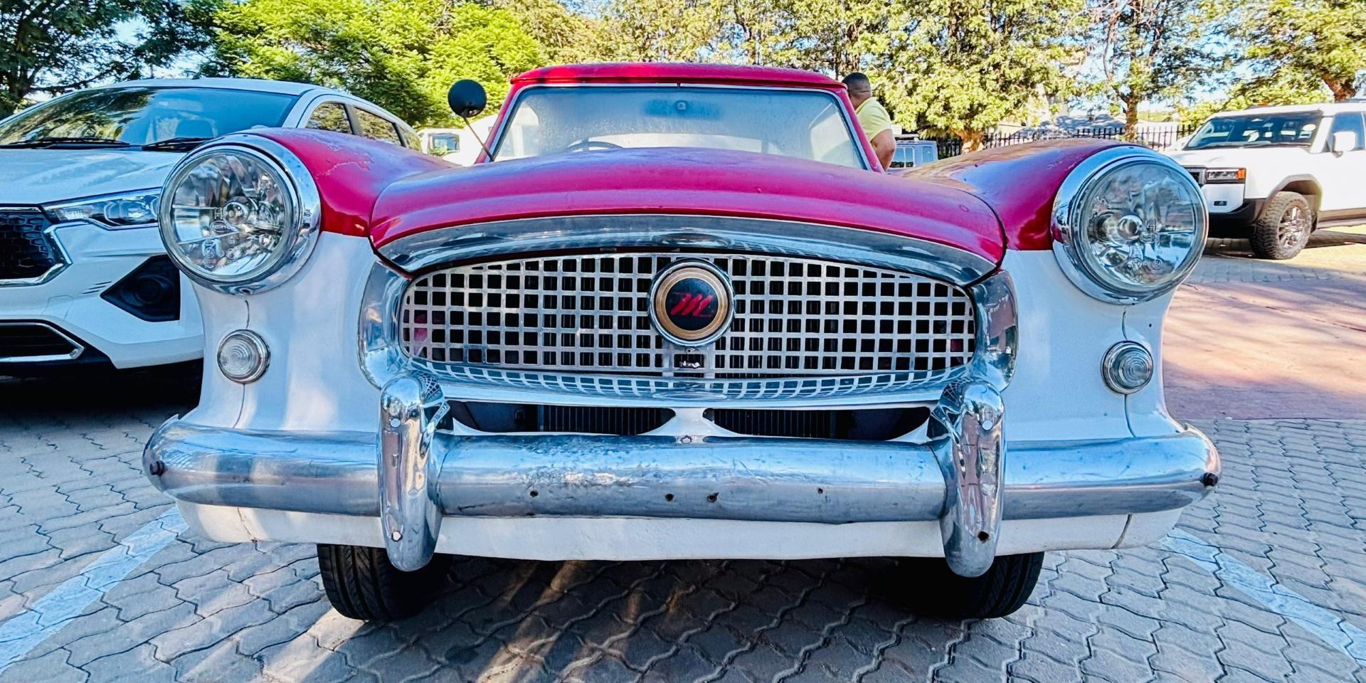Front view of the 1957 Nash Metropolitan Series III Hardtop in Namibia, showcasing its rounded vintage design, chrome grille and bumper details, circular headlights, and compact, classic 1950s styling.